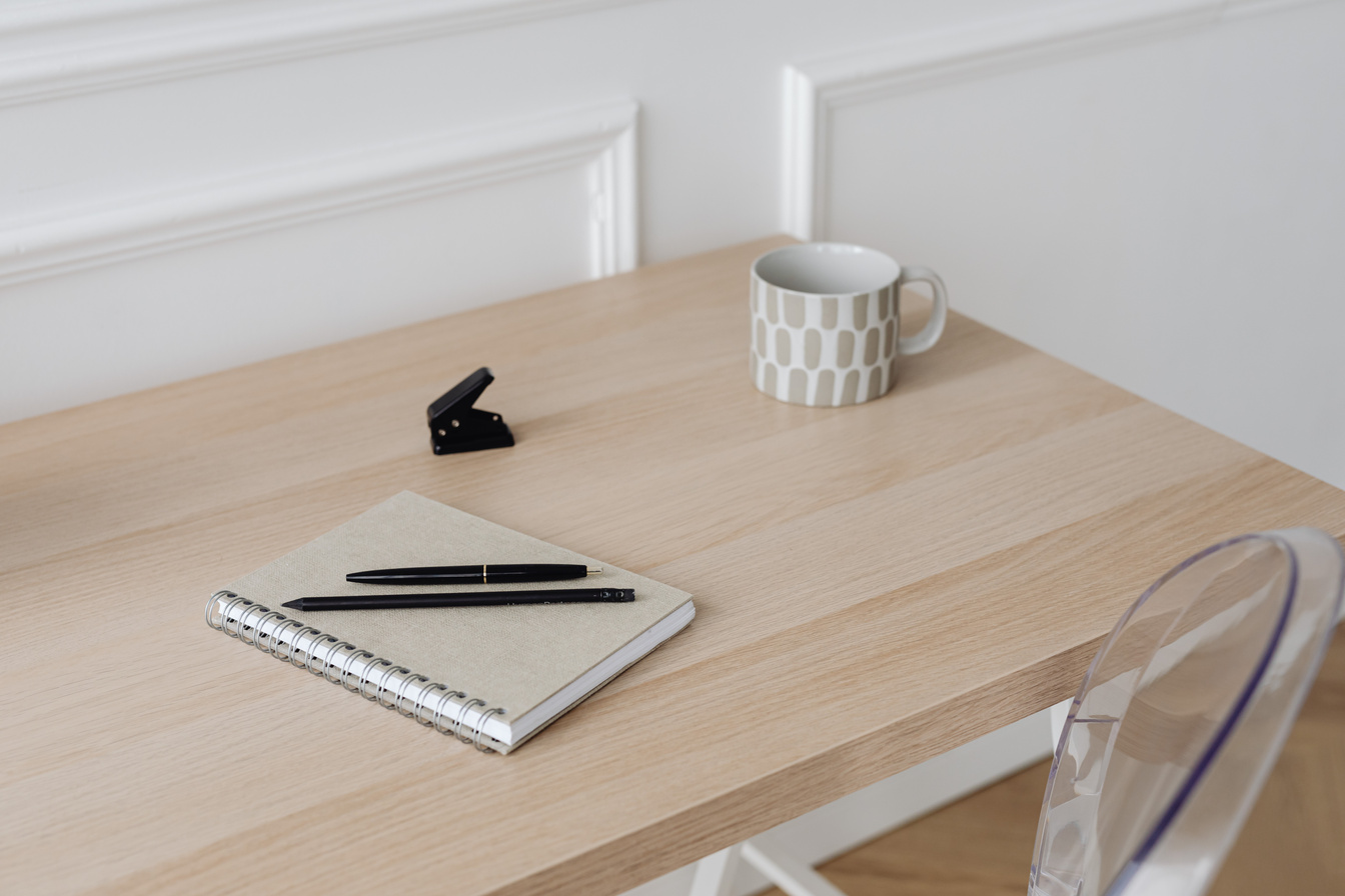 A Notebook and Pens on the Table